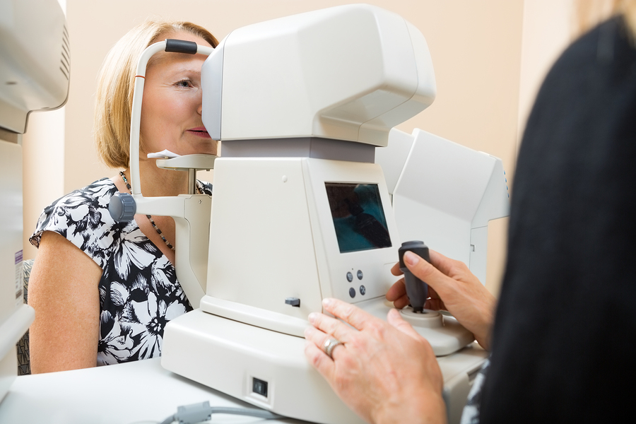 Female optician examining patient