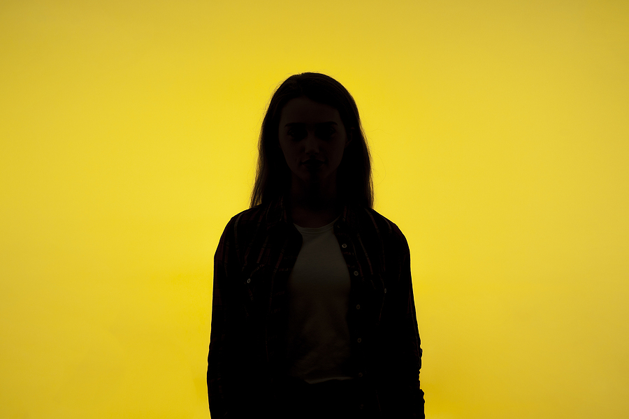 Hidden identity of woman on yellow background