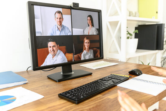 Image shows: large screen with video meeting participants