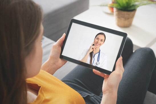 Image Shows: Health care provider talking with patient on video visit.