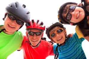 Image shows kids wearing protective sports glasses and helmets