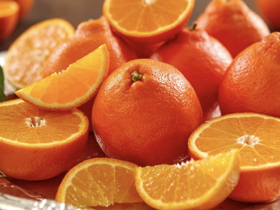 Image shows vibrant and delicious looking freshly picked oranges