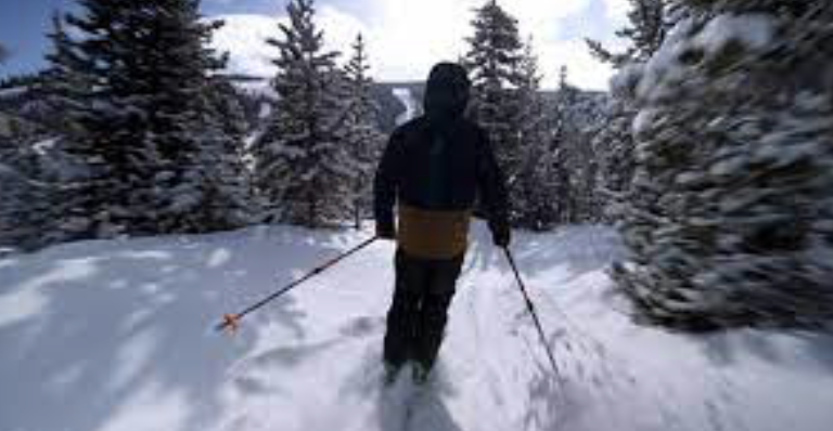 Jacob Smith, legally blind teen skiing on a casual run through the pines in Big Sky, Montana. Image credit cbsnews.com