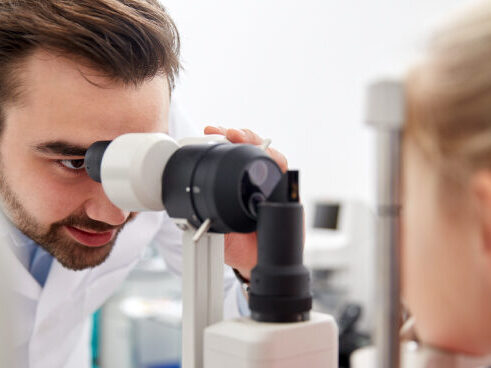 Ophthalmologist examining a patient's eye.