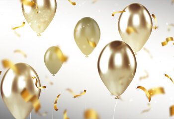 Celebratory golden balloons and confetti.