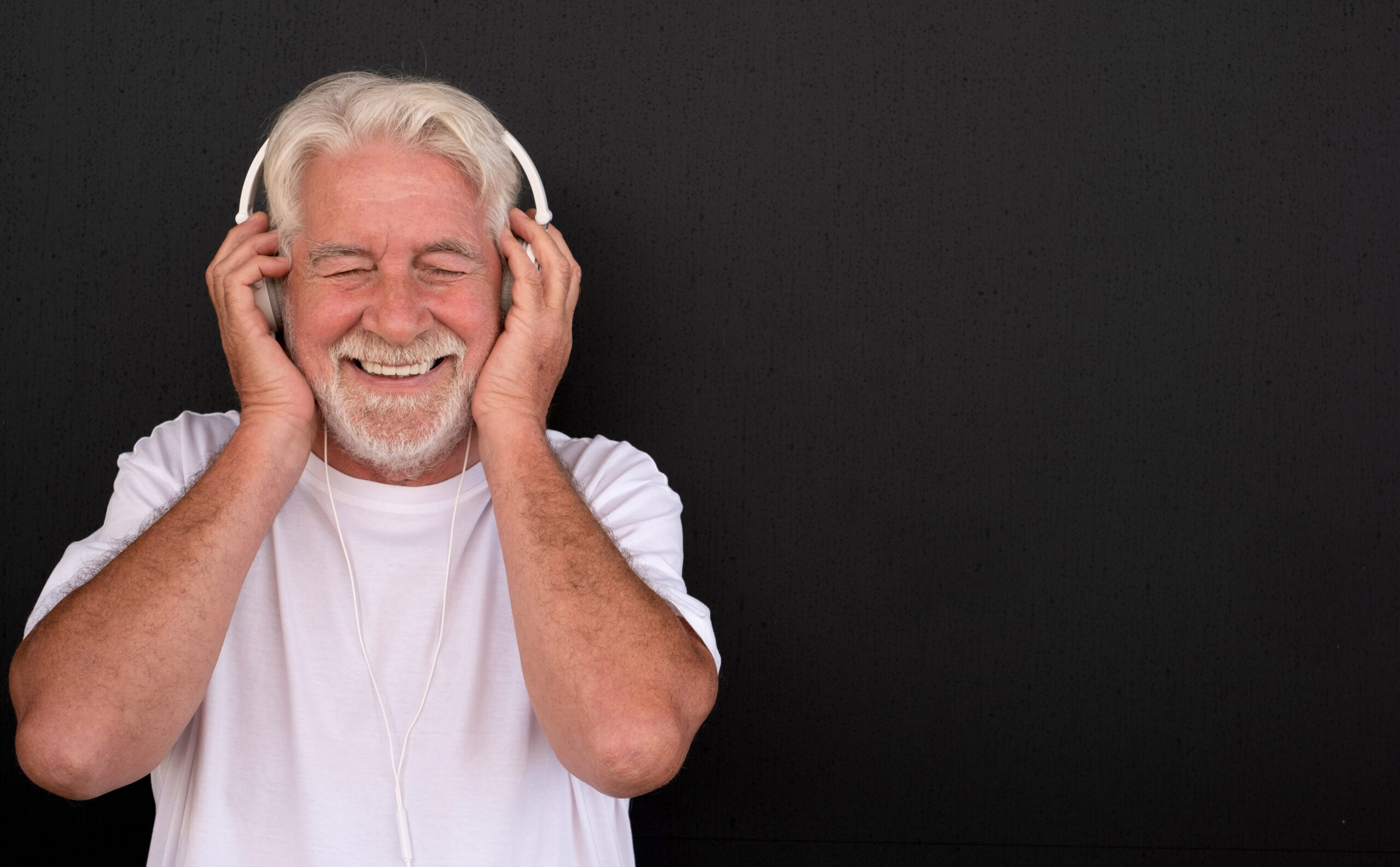 Man with headphones listening to audio magazine