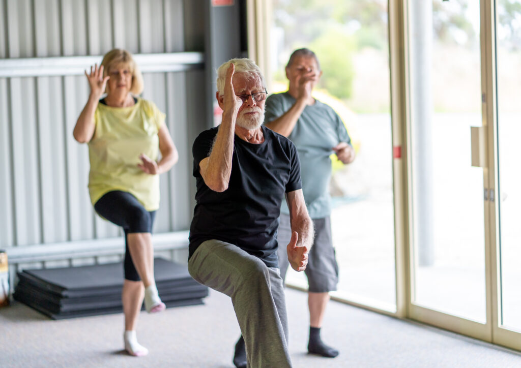 Older adults practicing Tai Chi exercises to strengthen balance