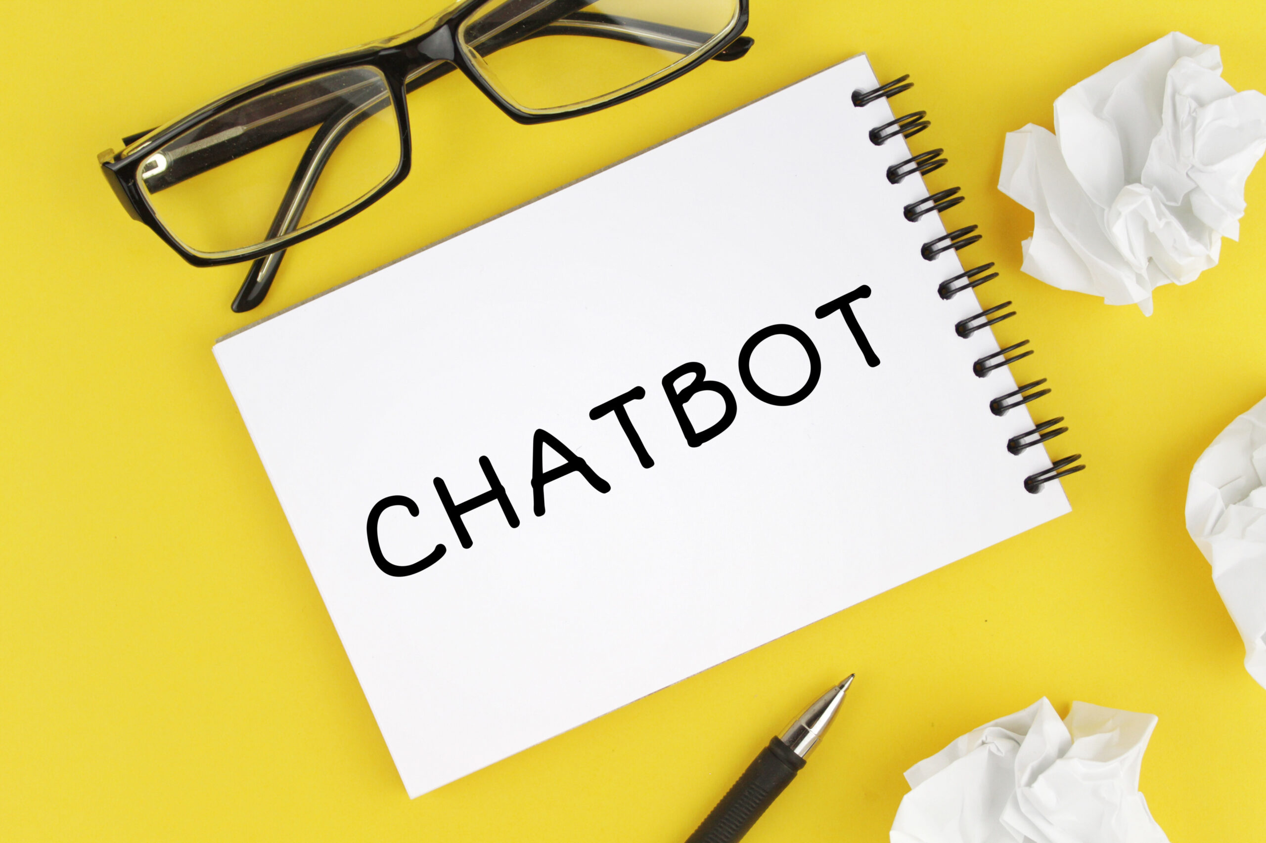 Chatbot written on notepad sitting on desk