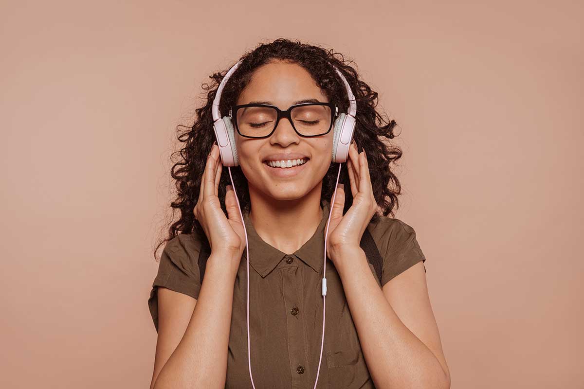 Women wearing white headphones enjoying audio magazine