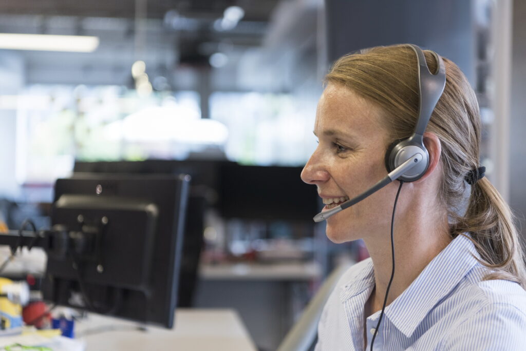 Accessibility support specialist helps customer with vision settings. 