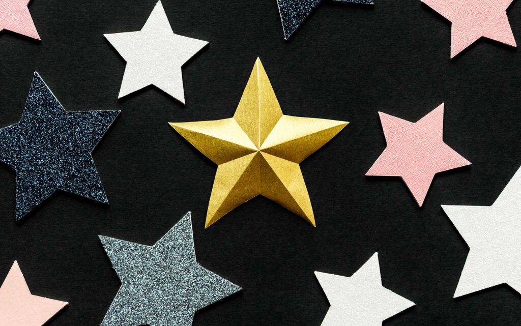 Gold, silver and white stars on black background