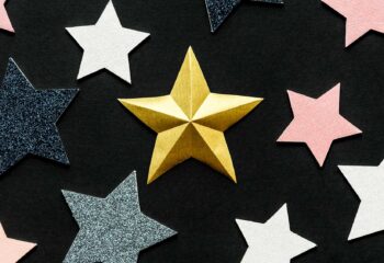 Gold, silver and white stars on black background
